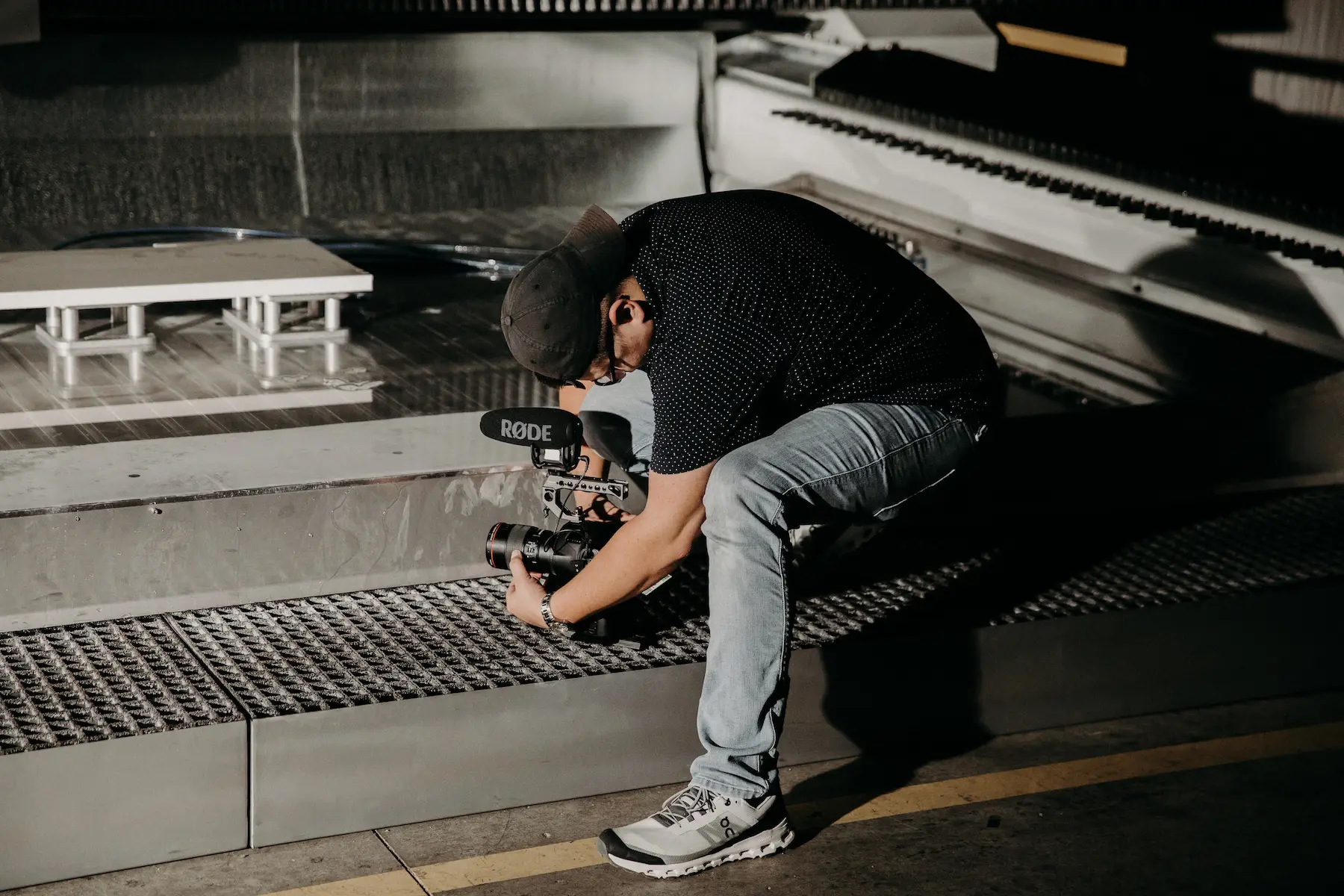 videographer getting marketing video for shoot with camera over water